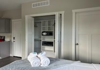 Closet beside bed and bathroom