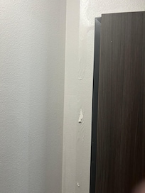 Water damage peeling paint in the room near the bathroom