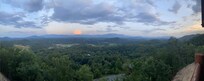Panoramic view with moon barely visible and sun setting behind us.