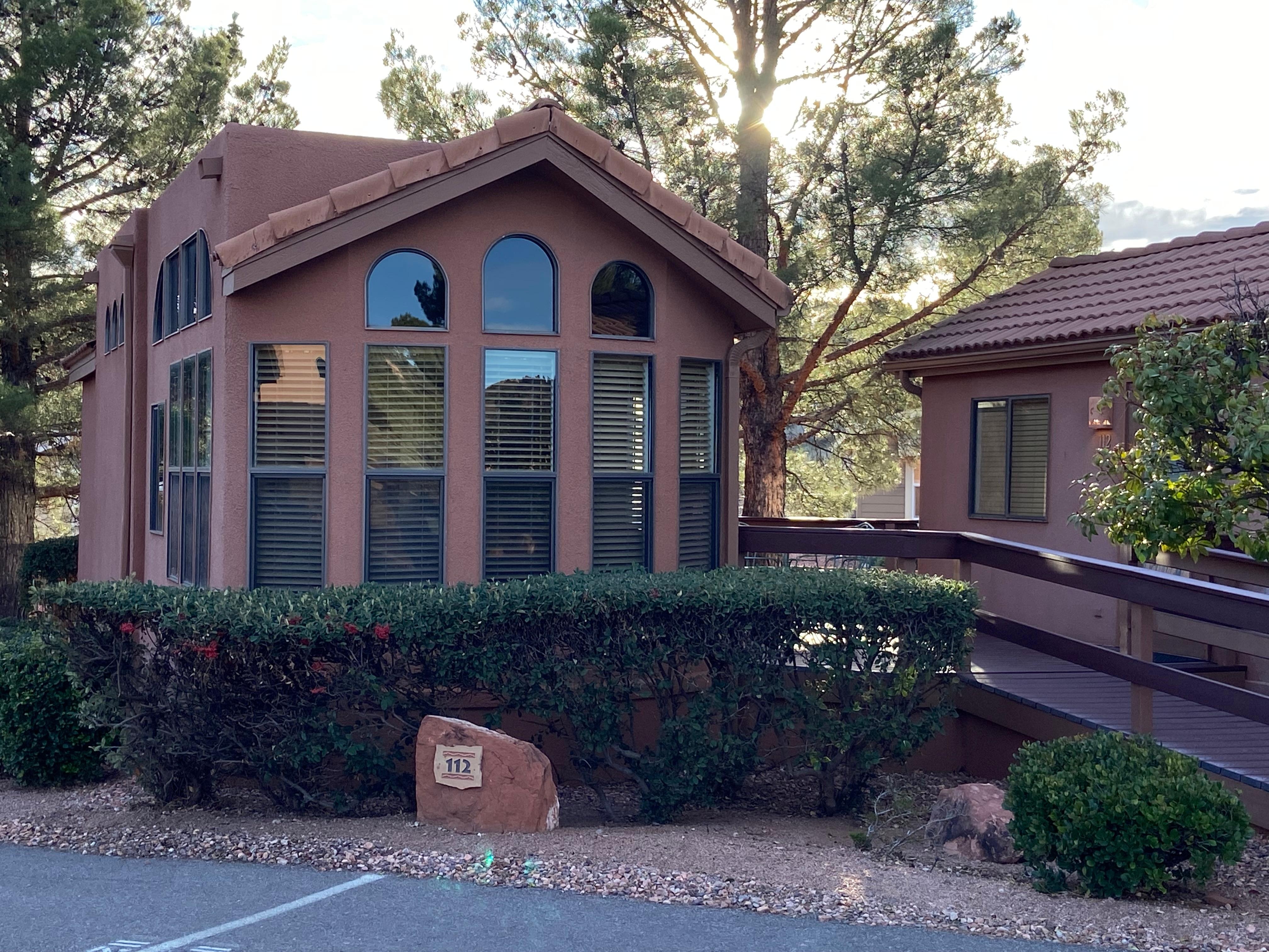 Two bedroom unit with deck and table and chairs between two bedrooms 