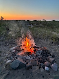 Backyard campfire at sunset