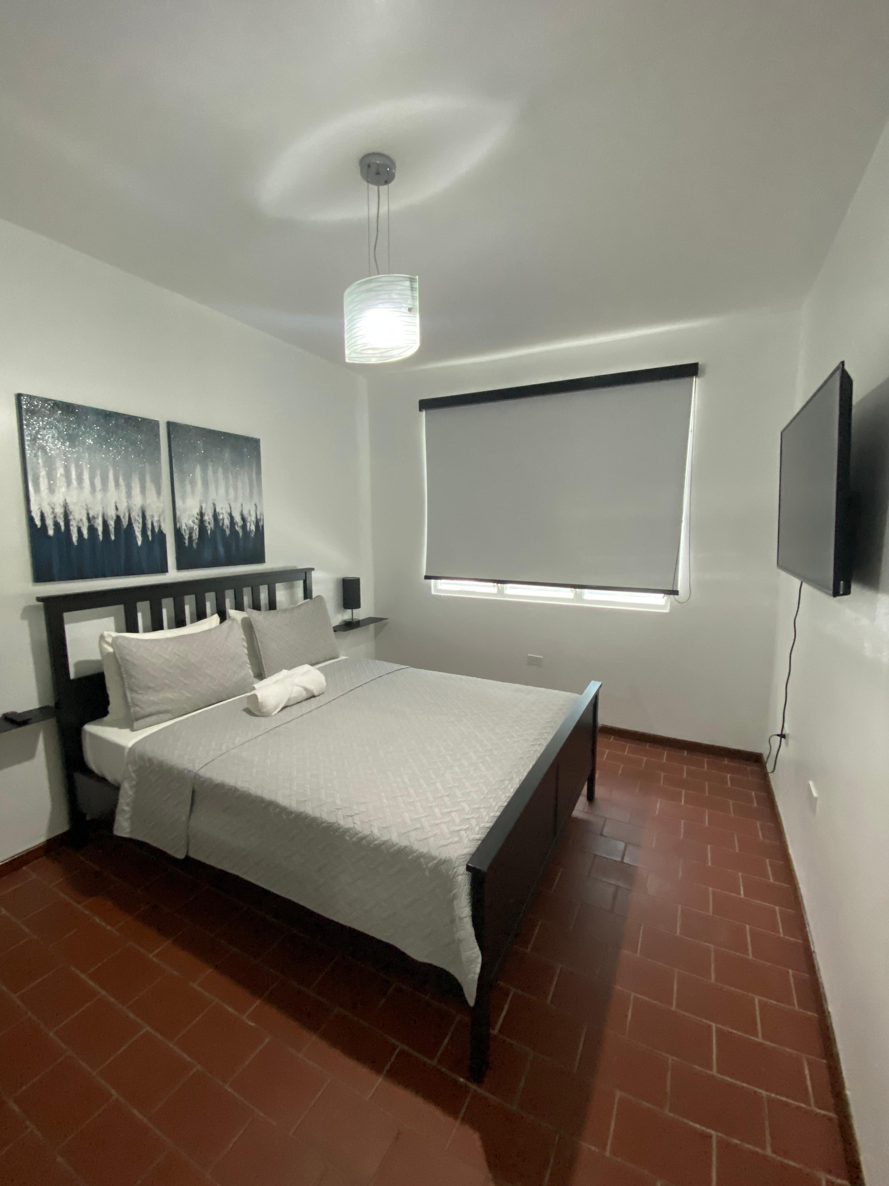 Great sized bedroom, full size closet with beach chairs, cooler, and ironing board provided by host. 