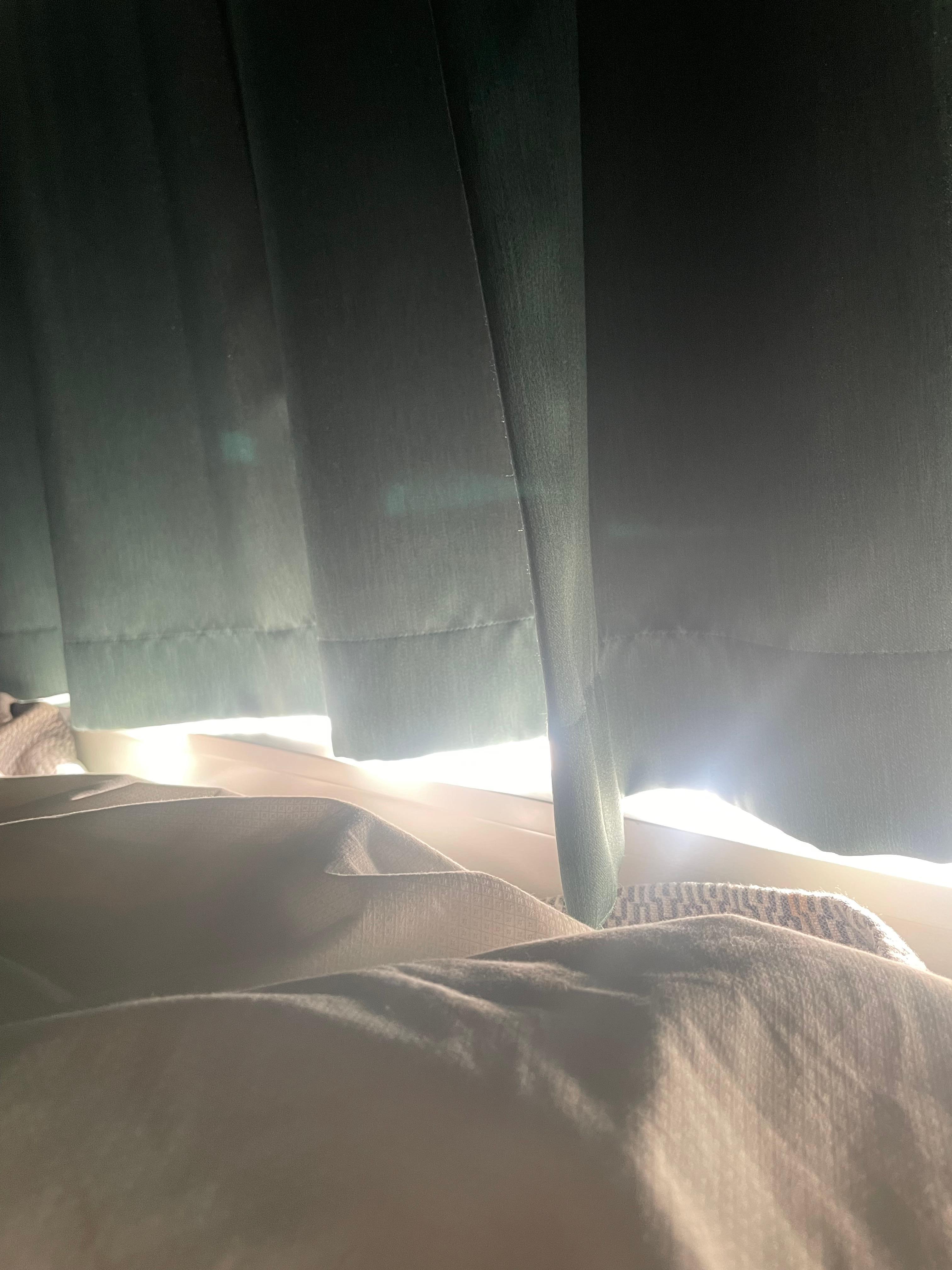 Bed next to window, curtains short and sunlight will wake you up 