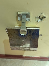 Toilet paper holder and hole in the washroom wall