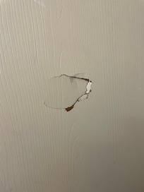 Hole behind the bathroom door