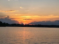 Beautiful sunset from the boat on the lake near the house