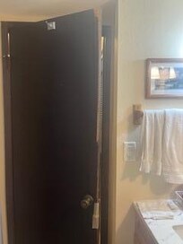 Wood coming off door in bathroom