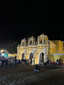 Across the street next to a small Mercado.