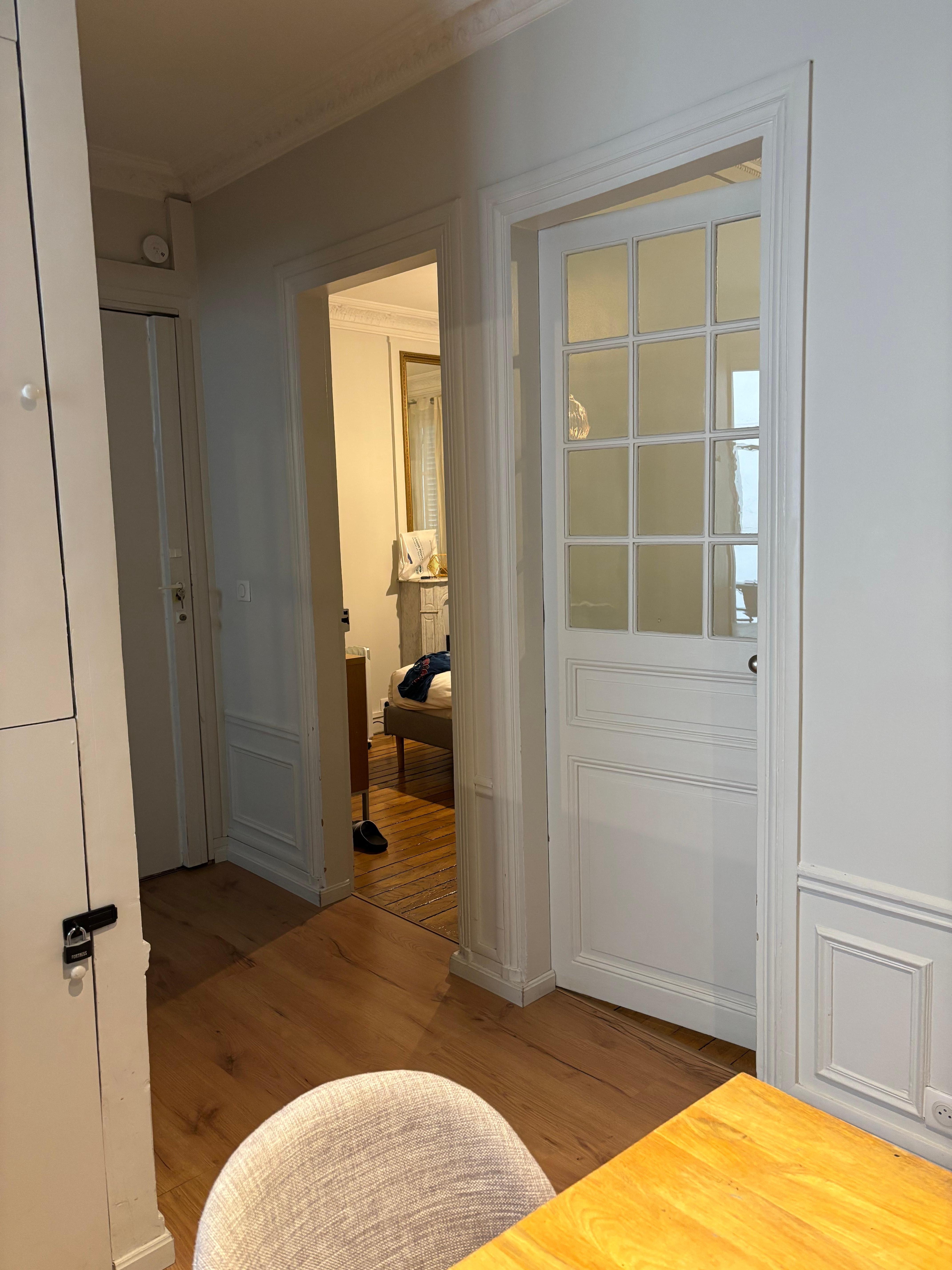 Looking from dining room toward  living room glass door and bedroom 