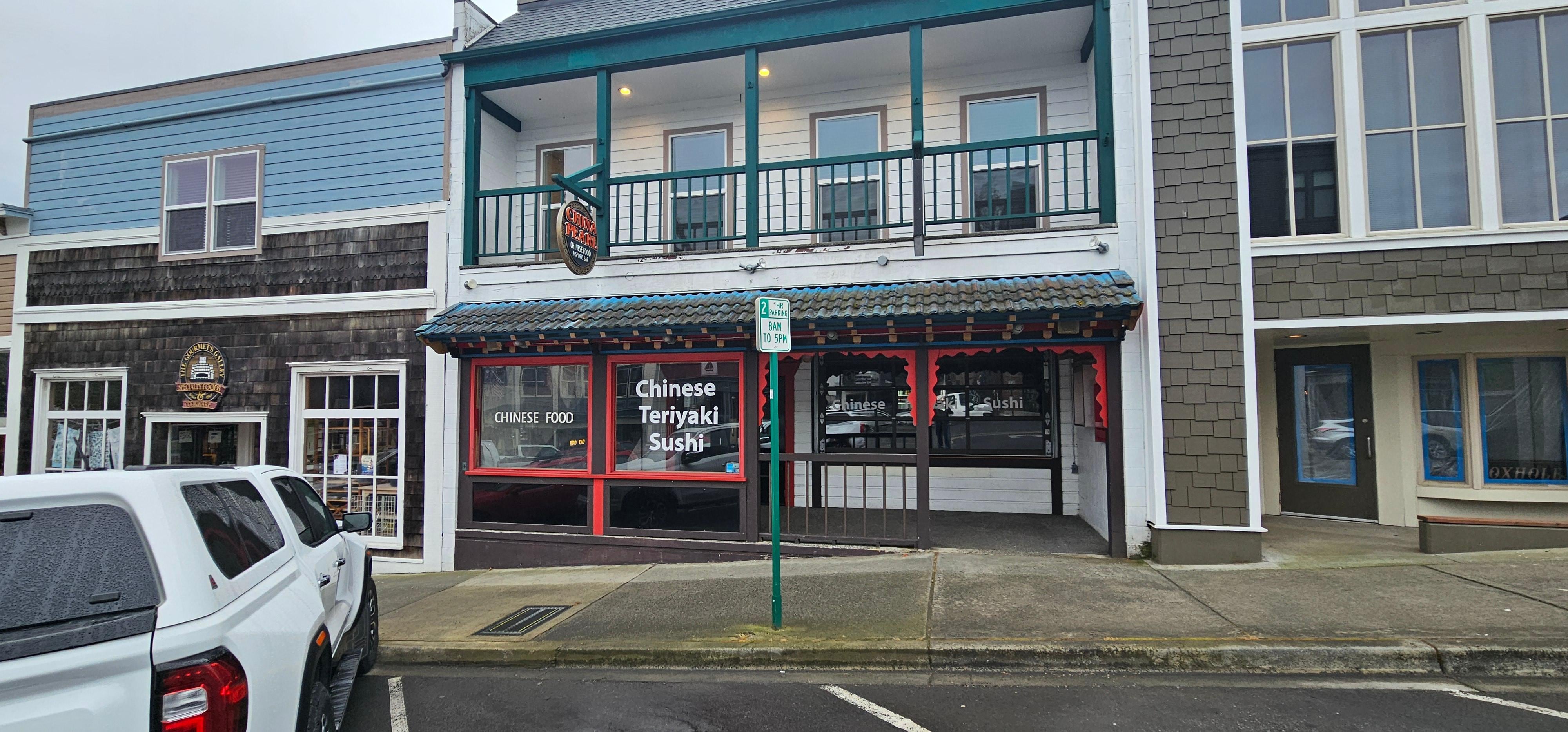 Front Entry to the rooms is in the same walkway as the Chinese restaurant. 3 windows above balcony are China Pearl room