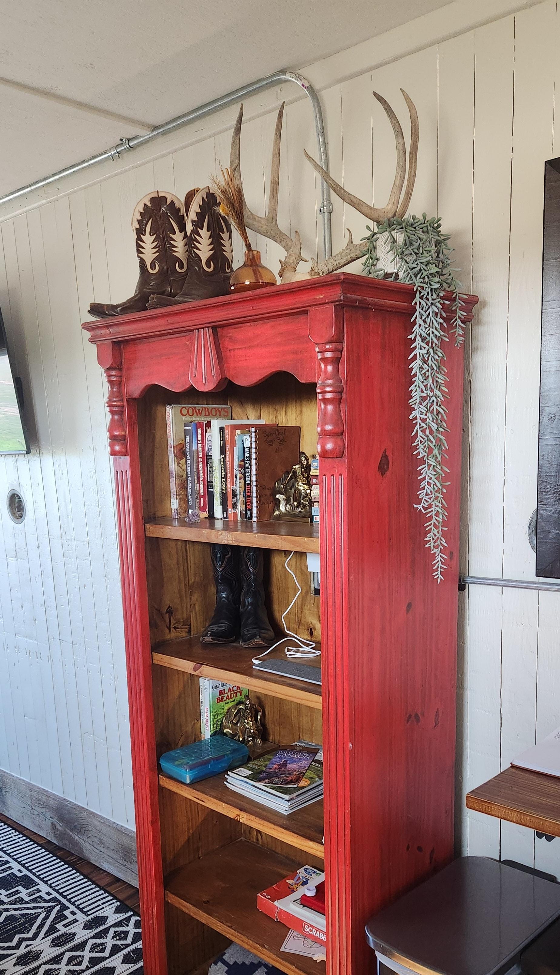 Bookcase with travel ideas, novels, board games