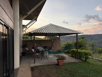 The outside table with chairs and hammocks from which you can watch the birds and the view.