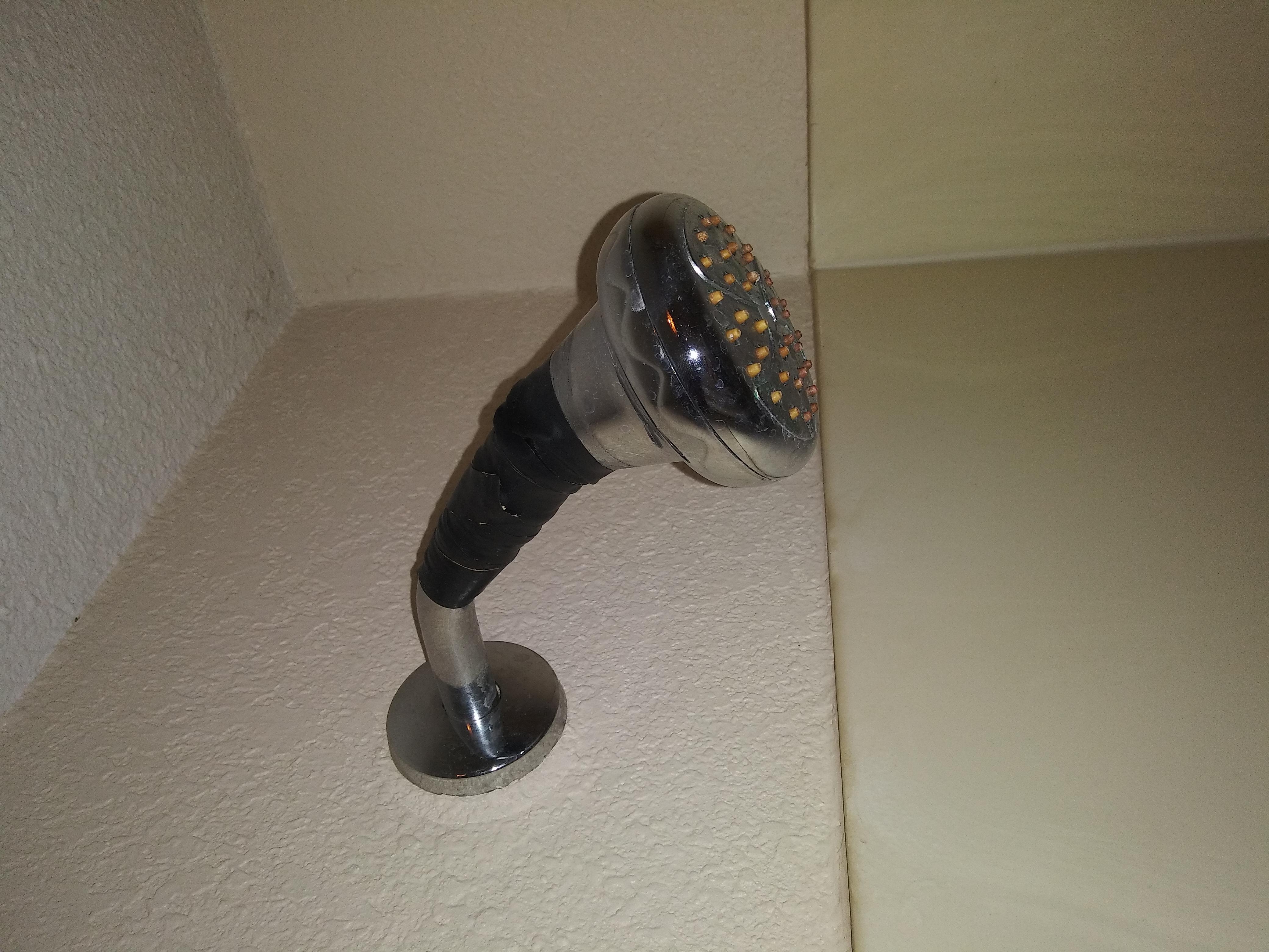 Taped on? Really.....

Drop 20$ on a new showerhead