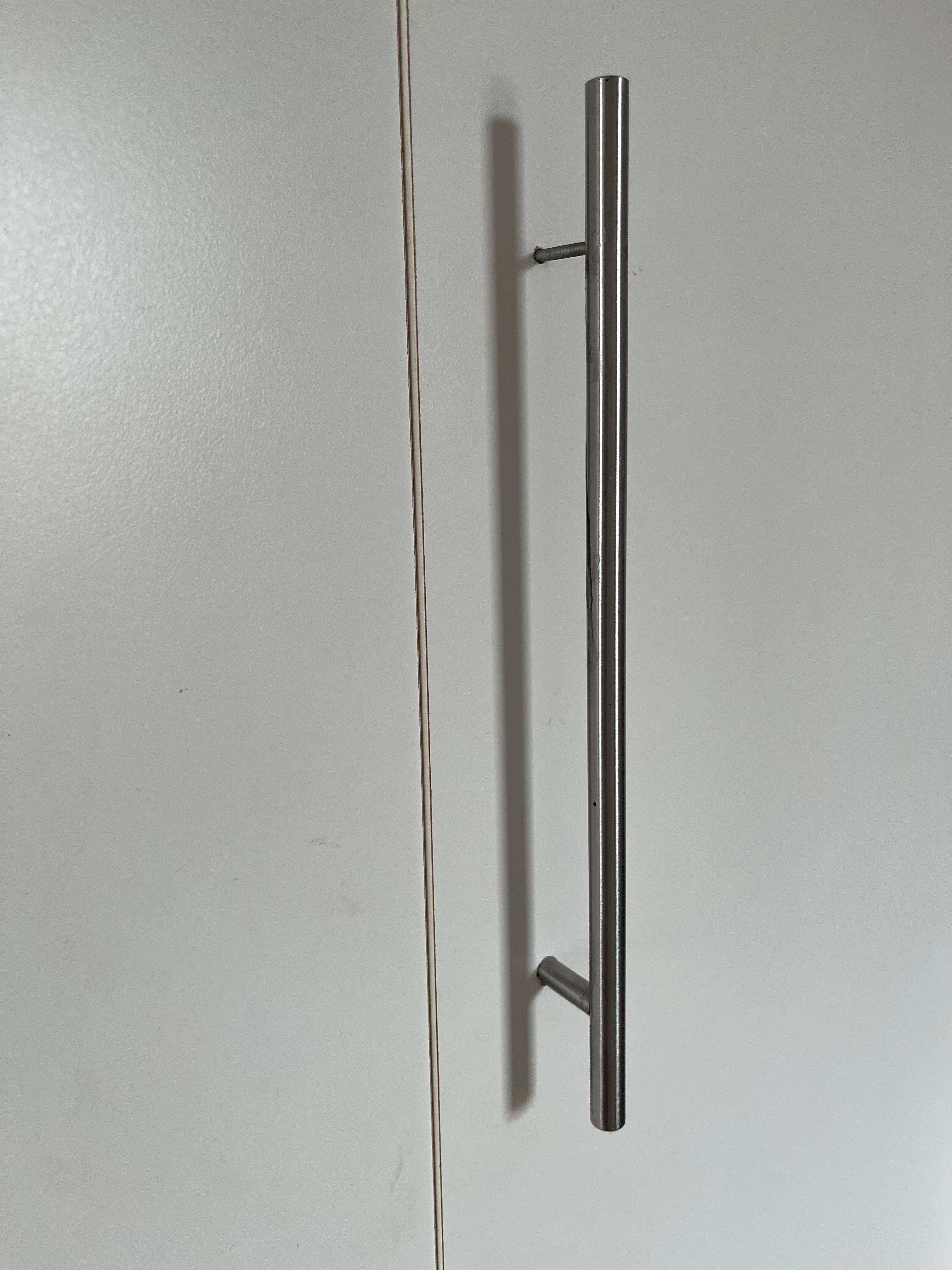 Cupboard handles on disrepair, moving inwards when touched.