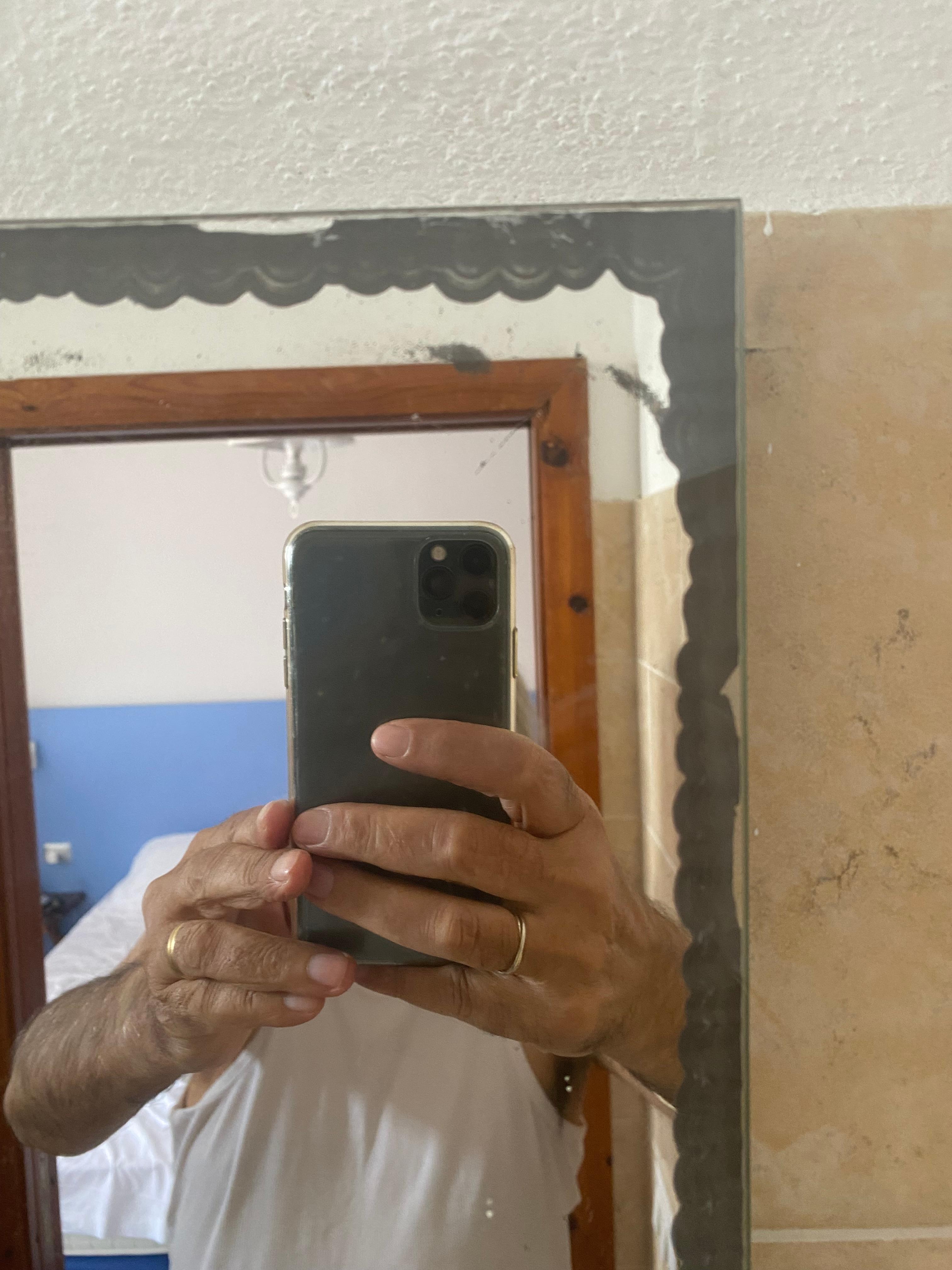 badly distressed mirror in bathroom