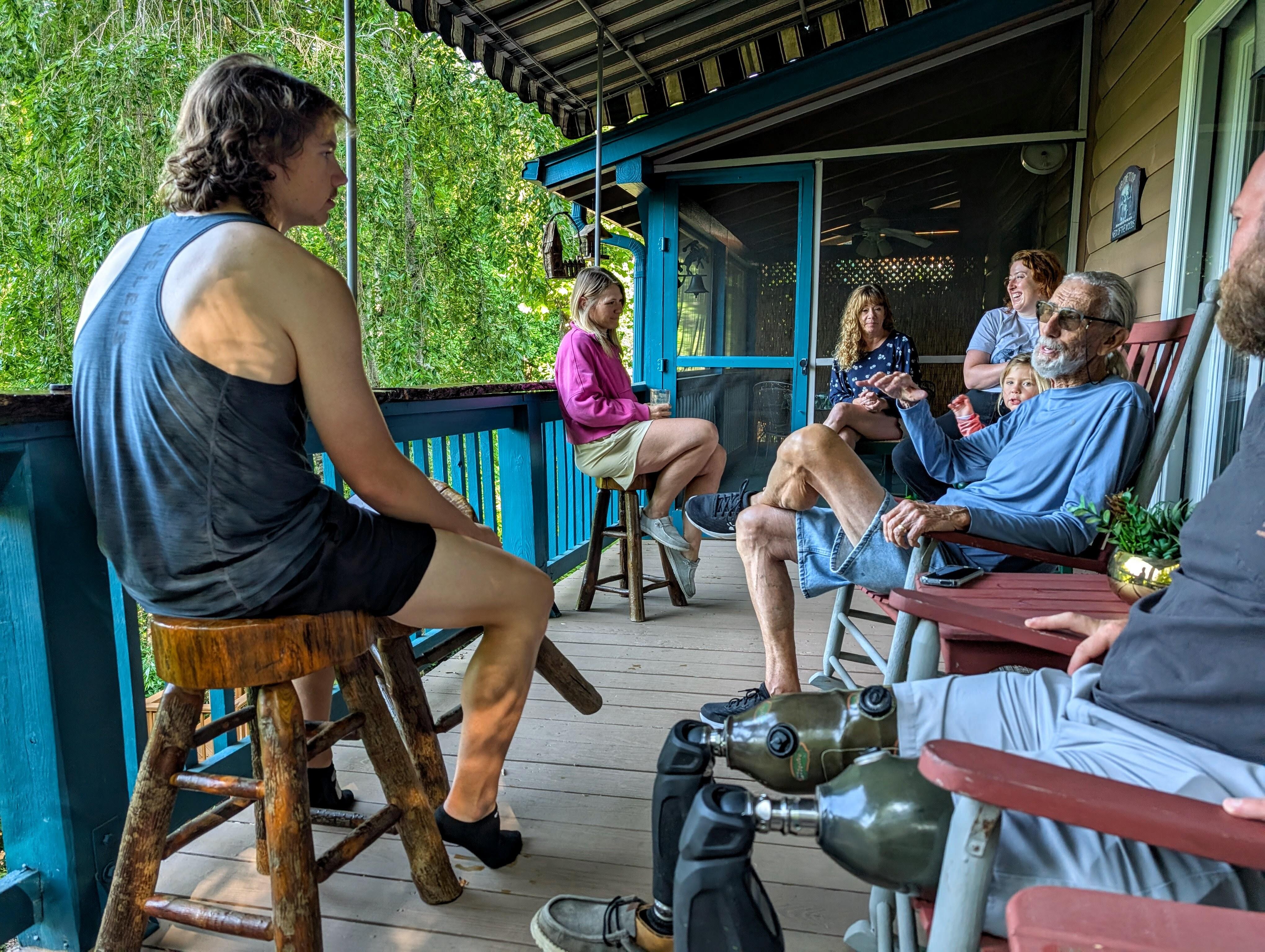 Four generations enjoying the porch and mountains