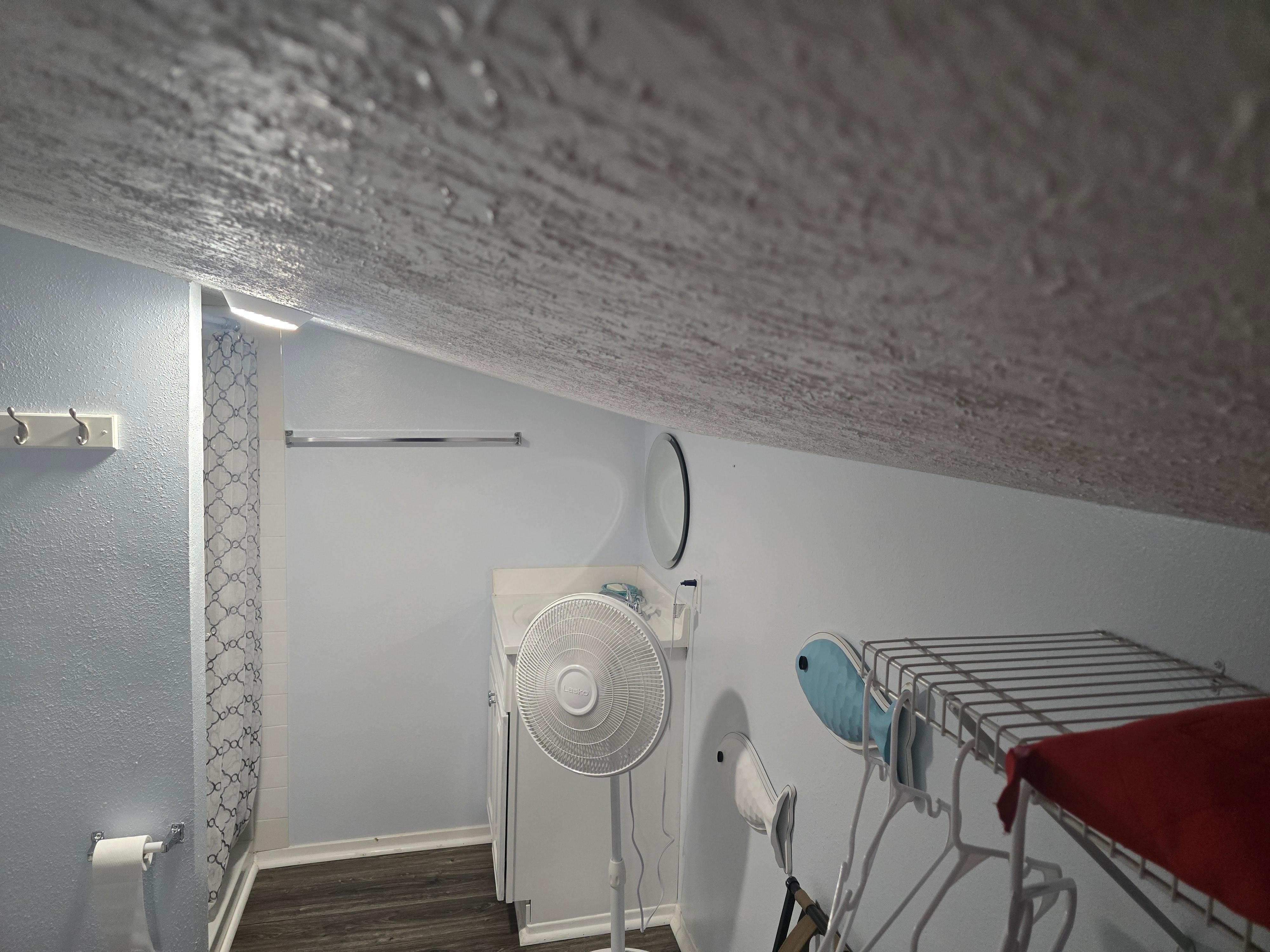 Upstairs bath with low ceiling and poor air conditioning.