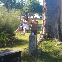 Our big kids enjoying the swing down by the river