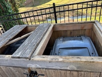 Broken trash can container with exposed nails