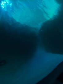 Huge flakes of debris all around hot tub and slimy surface.