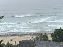 Ocean, beach with incoming tide and gravel beds