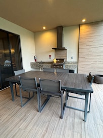 Outdoor dining space with grill and sink