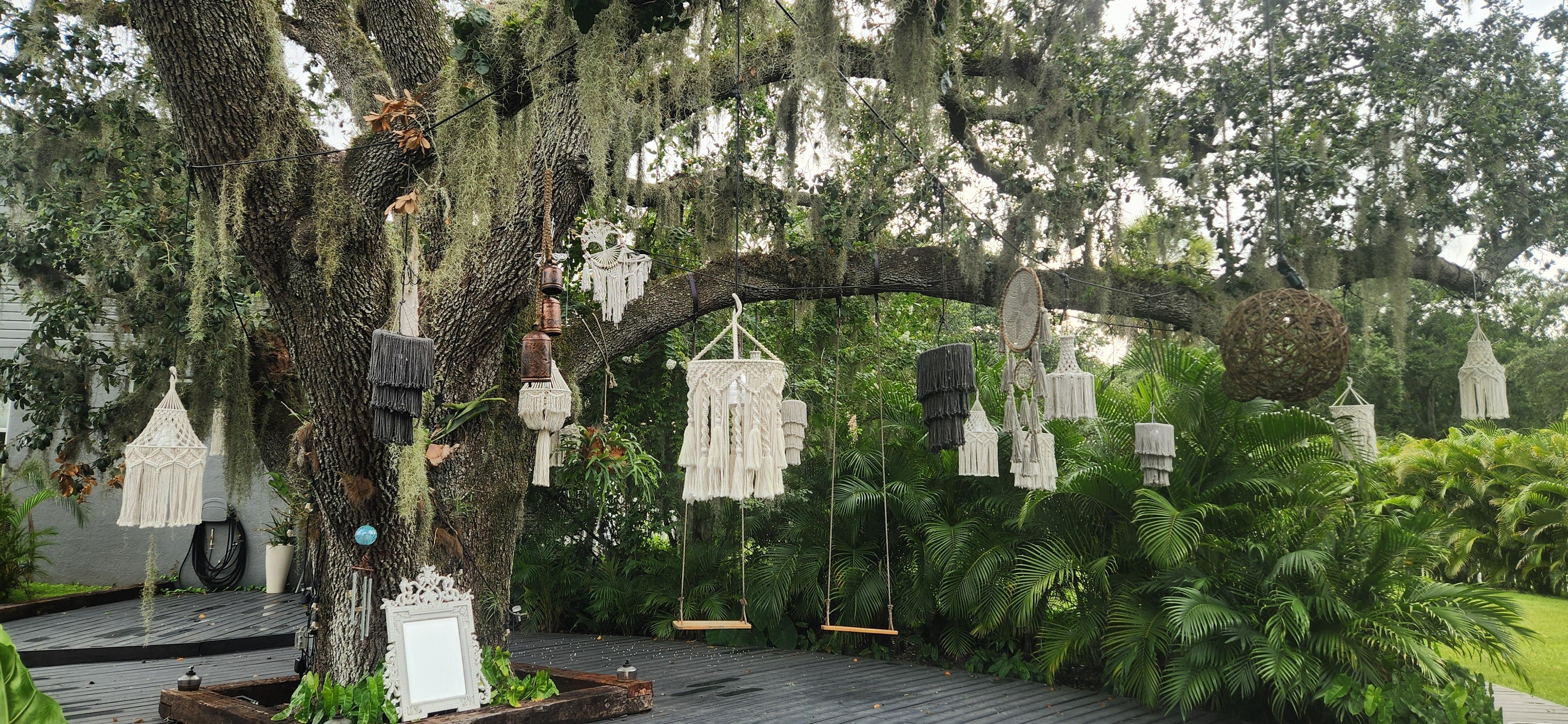 Macrame lanterns hanging from tree.