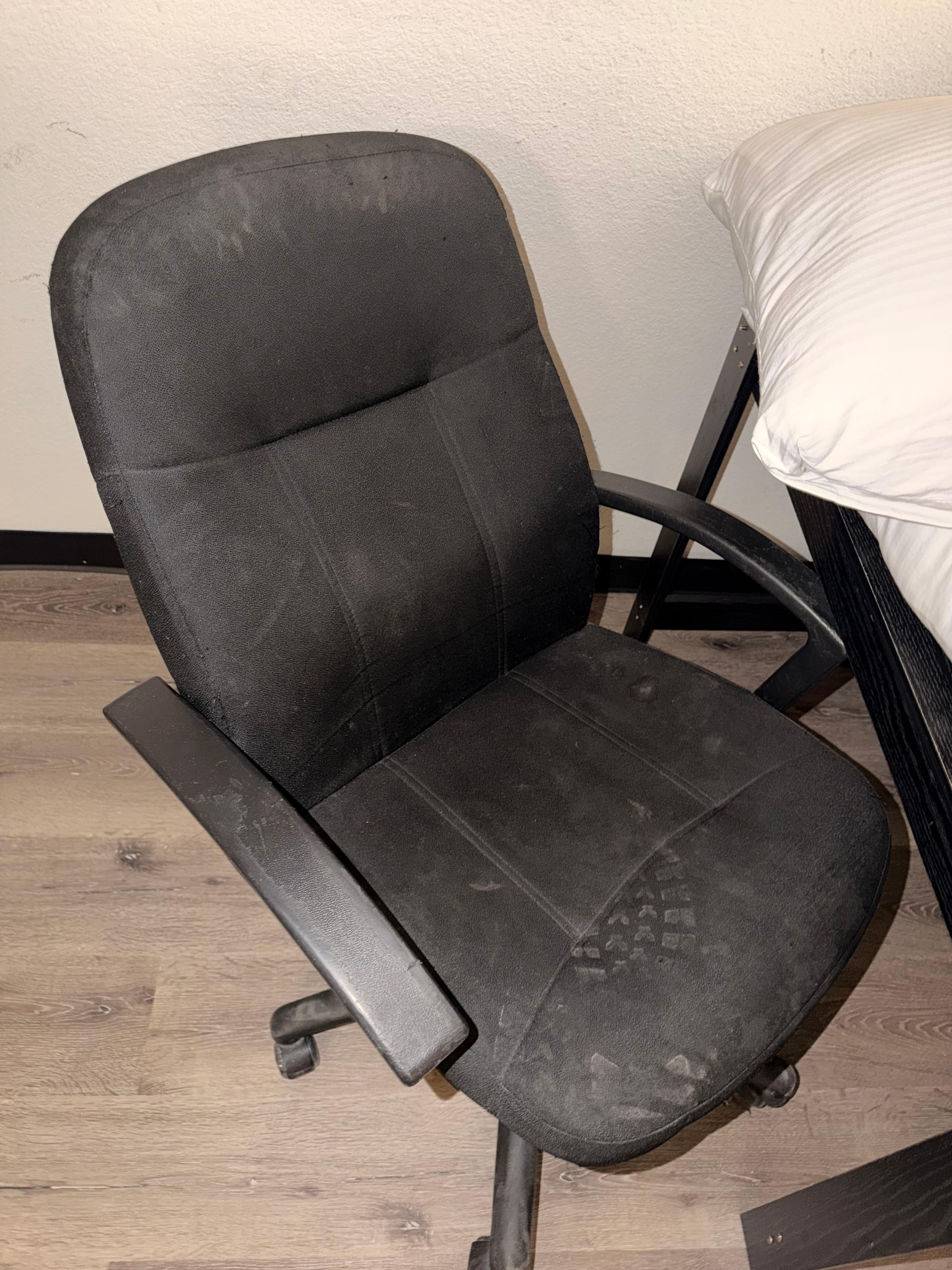 Broken desk chair with boot marks 