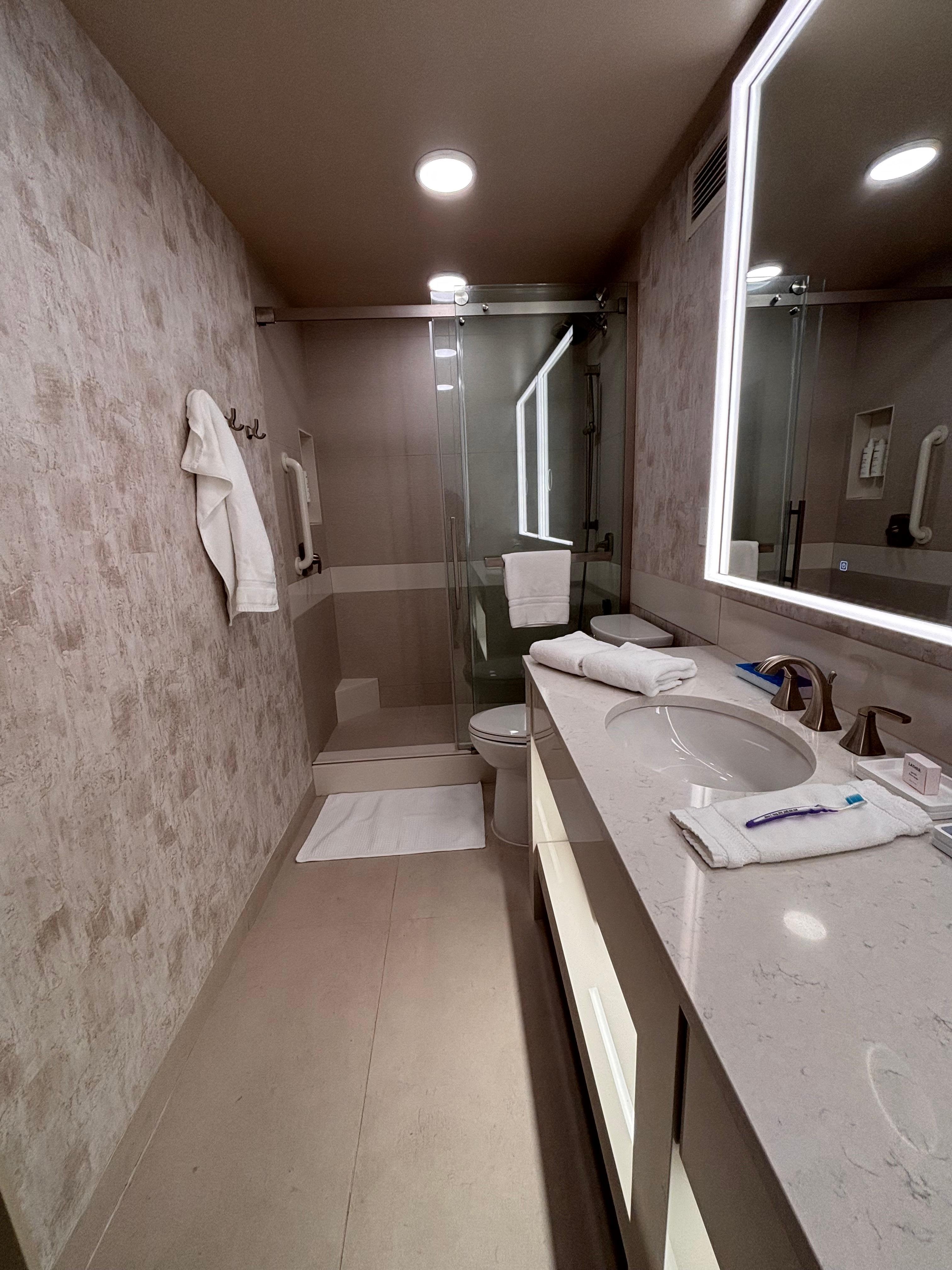 The bathroom is spacious and features a large shower, double sinks, lighted mirrors and automatic motion-sensors lighting especially appreciated when approached in the evening. 