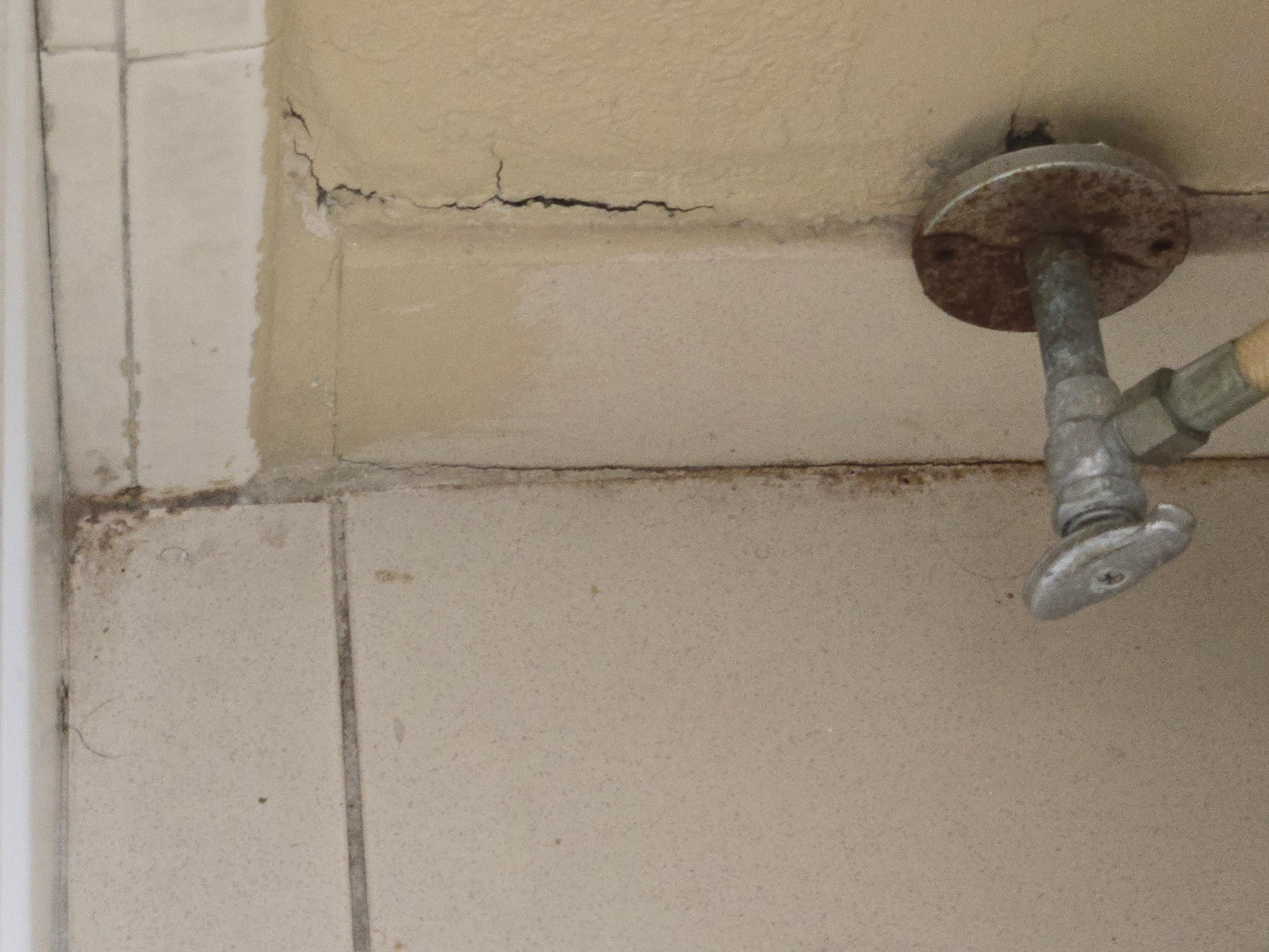 The floor behind the toilet 