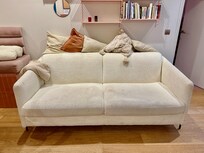 Filthy upholstery on sofa. No rug. No mirror coffee table. (There is a tiny plastic table there instead.)