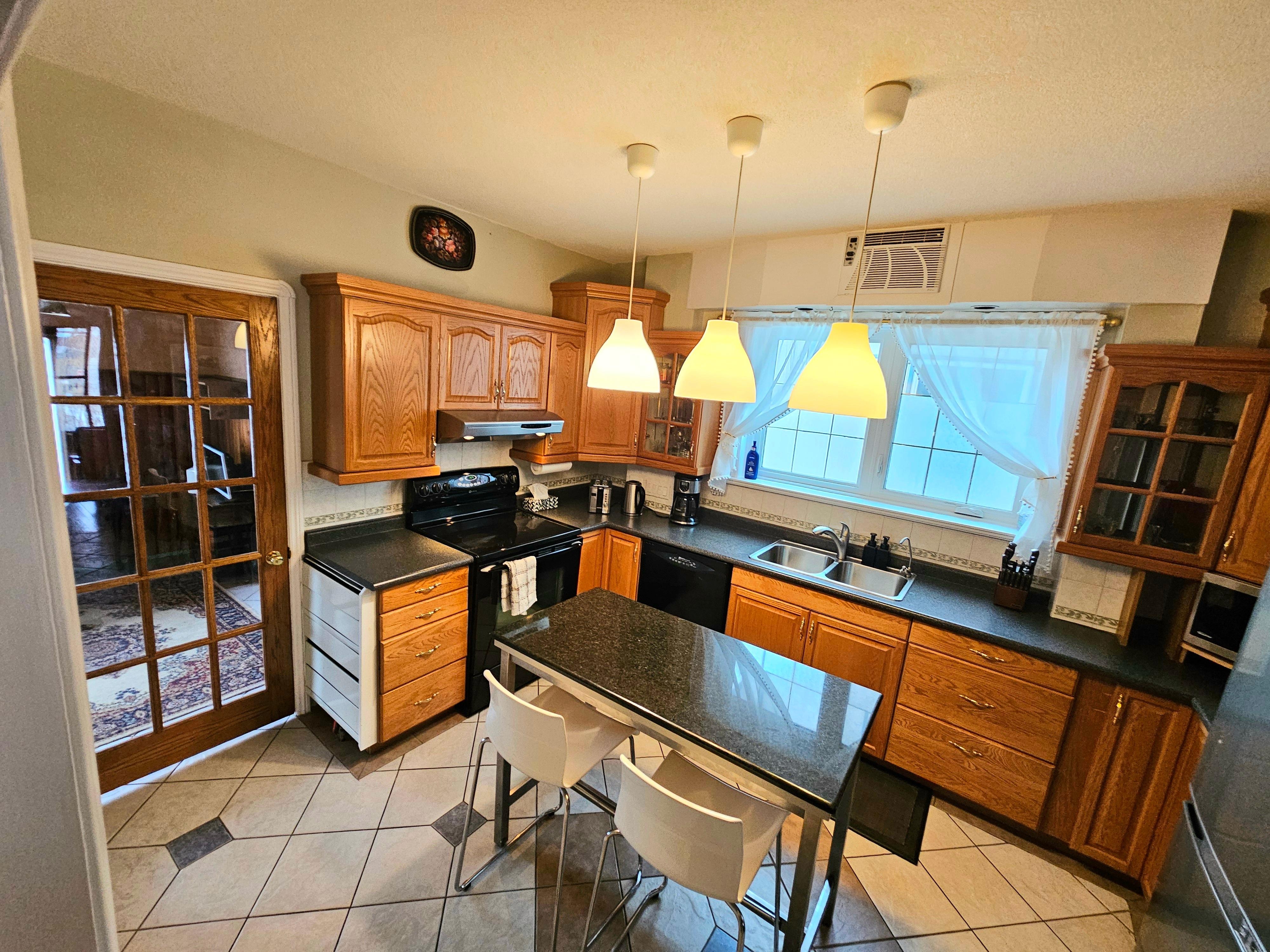 Big comfy kitchen with loads of cooking utensils and supplies. Dishwasher and tablets. To the left is the second bathroom with a washer/dryer!