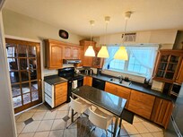 Big comfy kitchen with loads of cooking utensils and supplies. Dishwasher and tablets. To the left is the second bathroom with a washer/dryer!