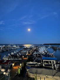 Early morning full moon setting on the bay