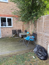 Discarded paddling pool and rubbish left outside