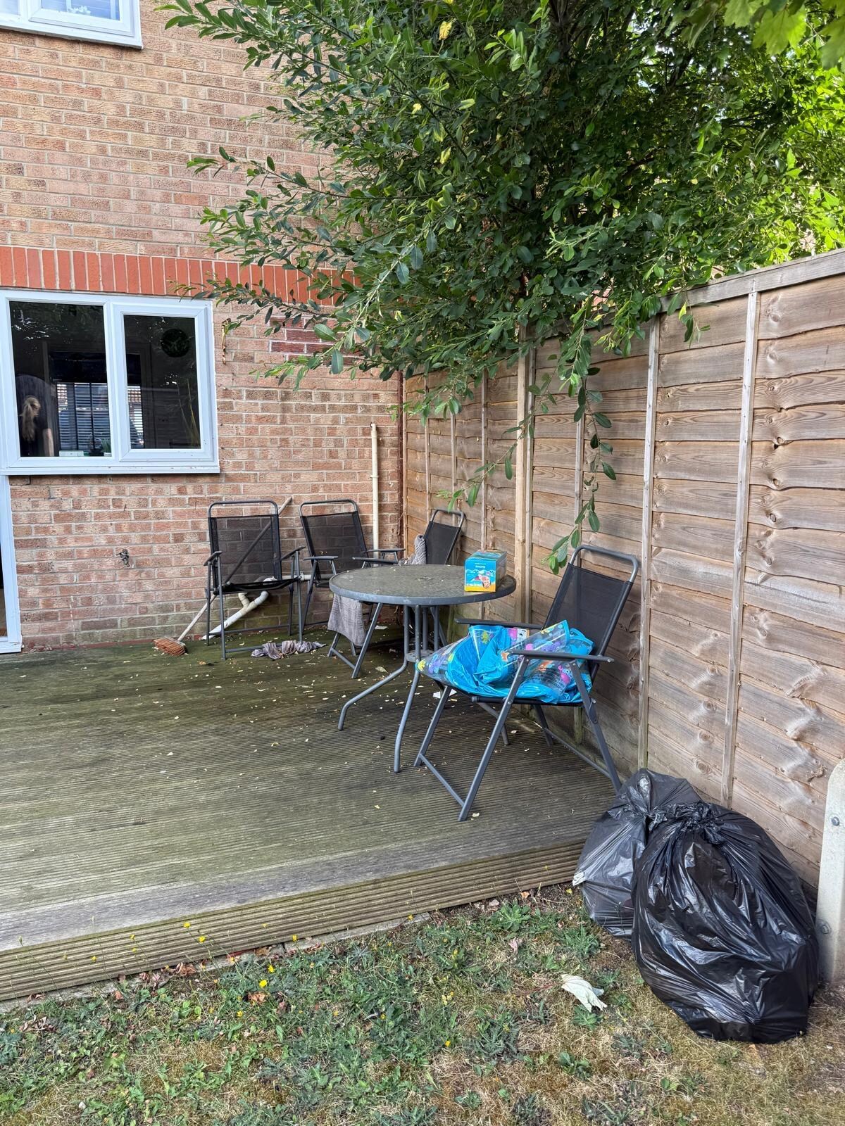Discarded paddling pool and rubbish left outside 