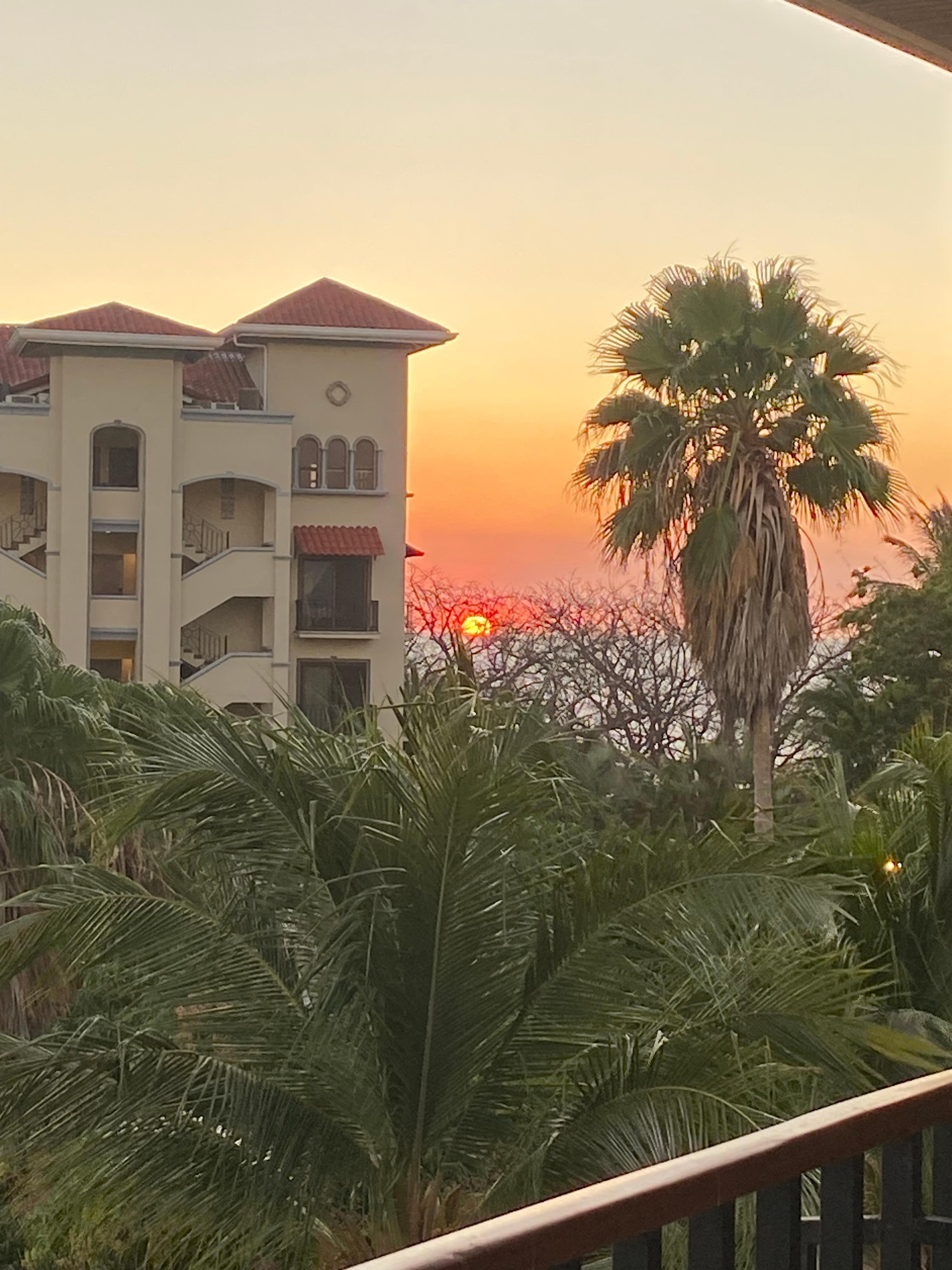 Sunset viewoff far edge of large balcony. 
