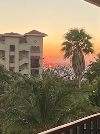 Sunset viewoff far edge of large balcony.