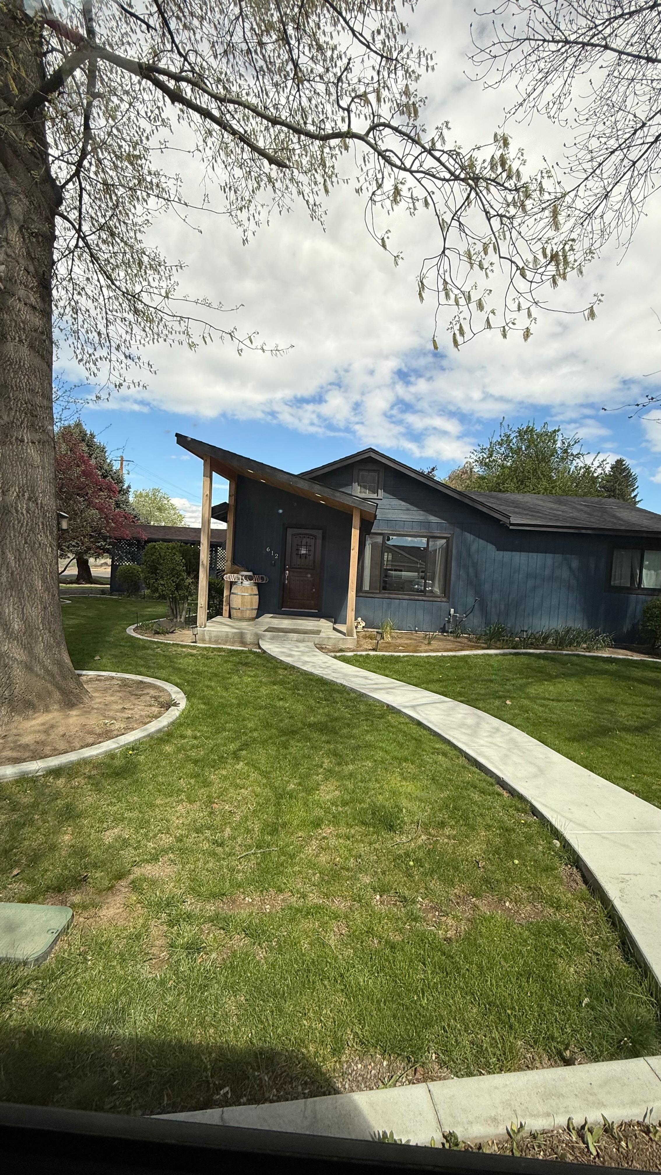 Manicured front and side yards with tree swing 