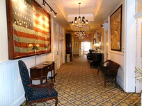 My hallway, big ol' antique American flag, period decor and chandeliers