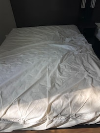 Stained and dirty sheets. Torn mattress