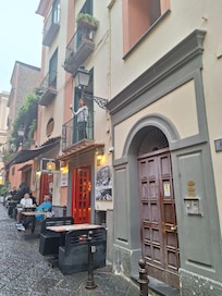 Entrance next to Frankie’s Pizza Bar