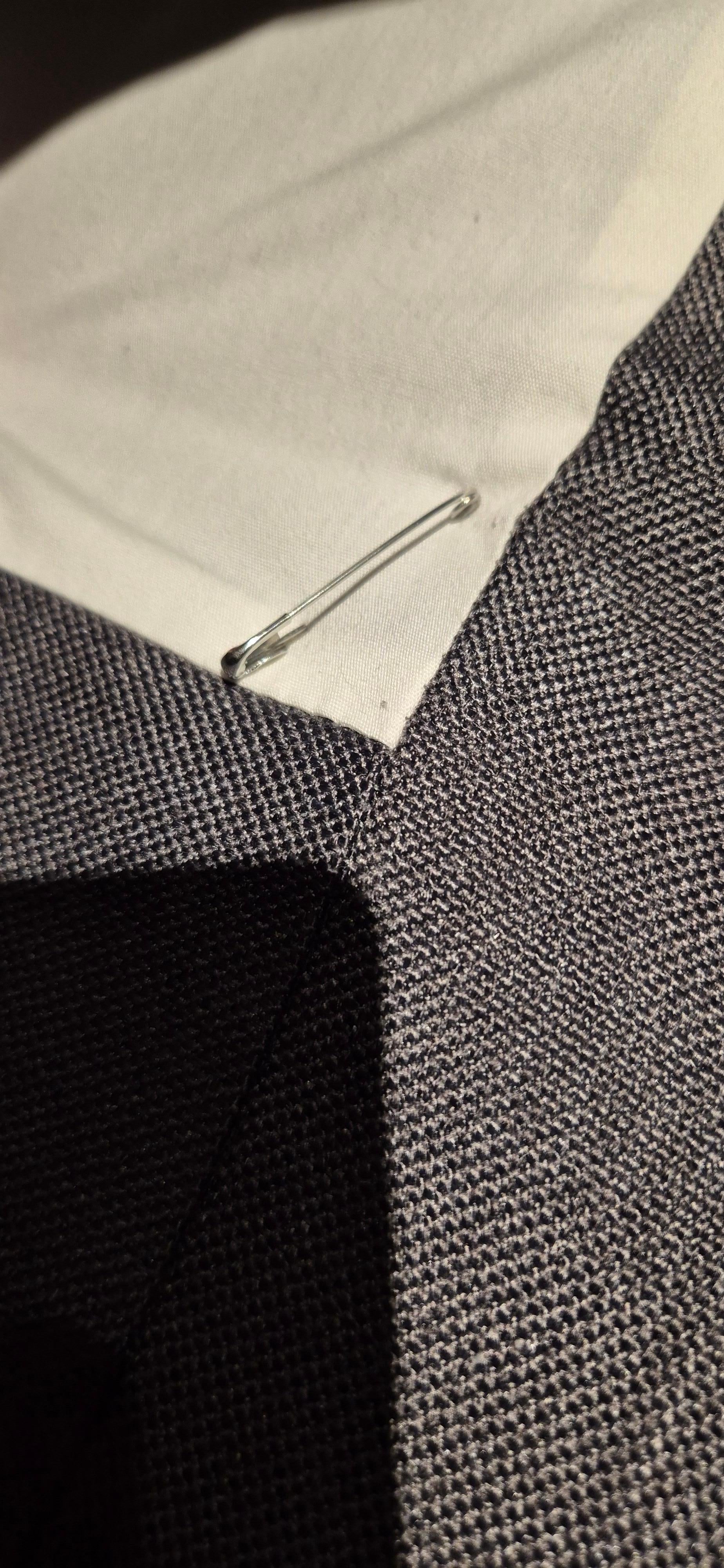 safety pin holding on cover - not safe under a topper - and near your head and feet