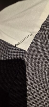 safety pin holding on cover - not safe under a topper - and near your head and feet