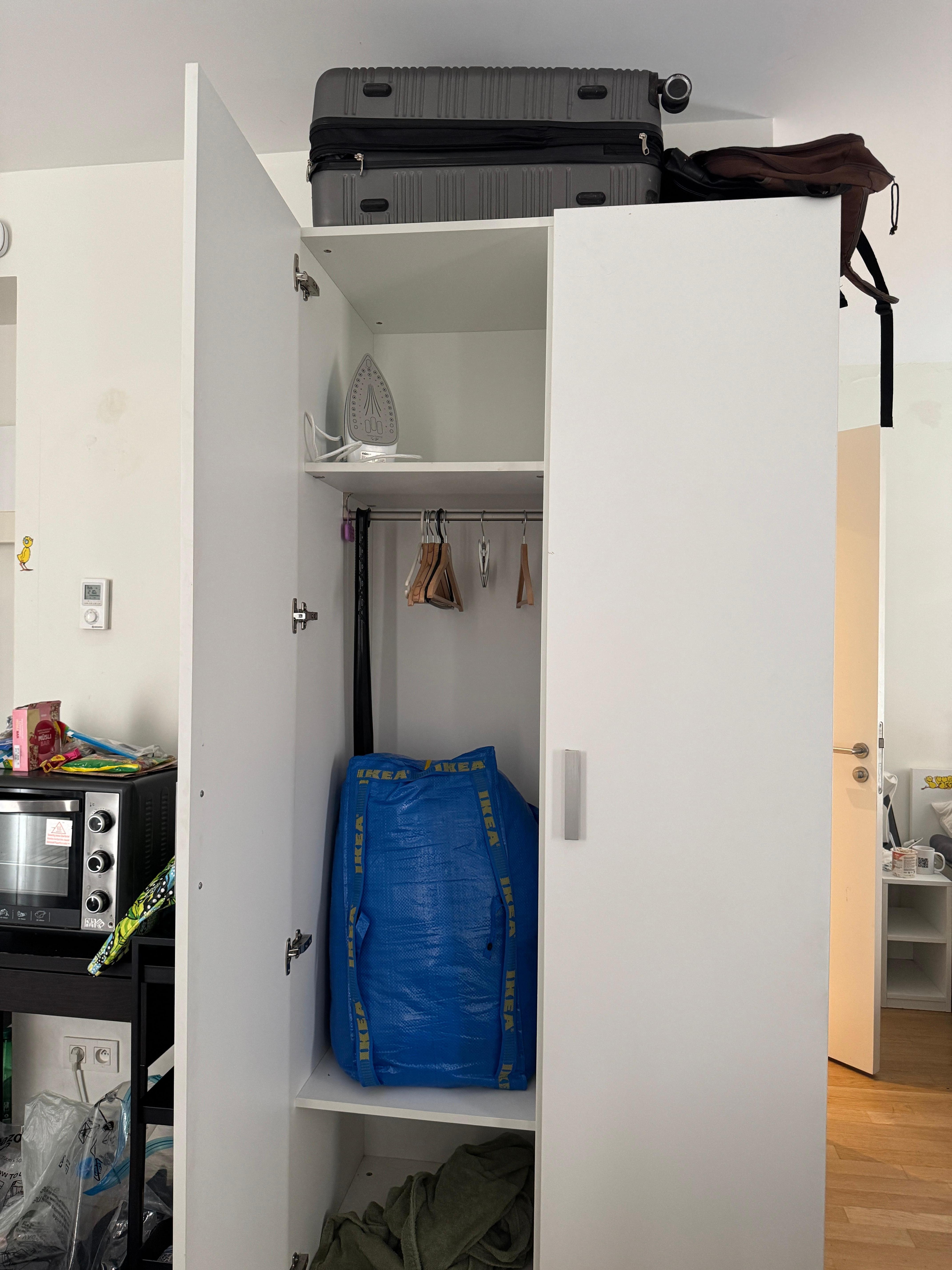 Host suitcases above the wardrobe and bags inside 