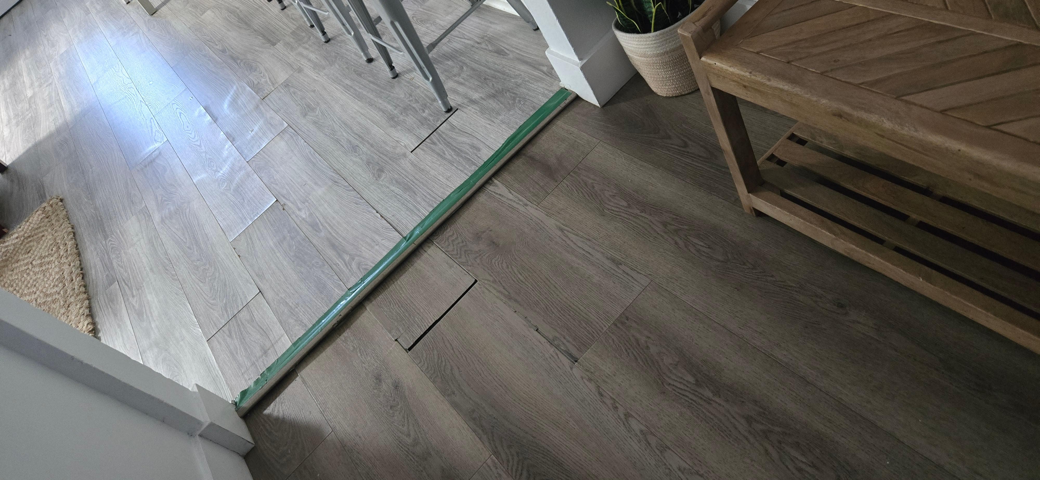 The property photos show a nice orange tile, which has been replaced by cheap flooring thats already damaged.