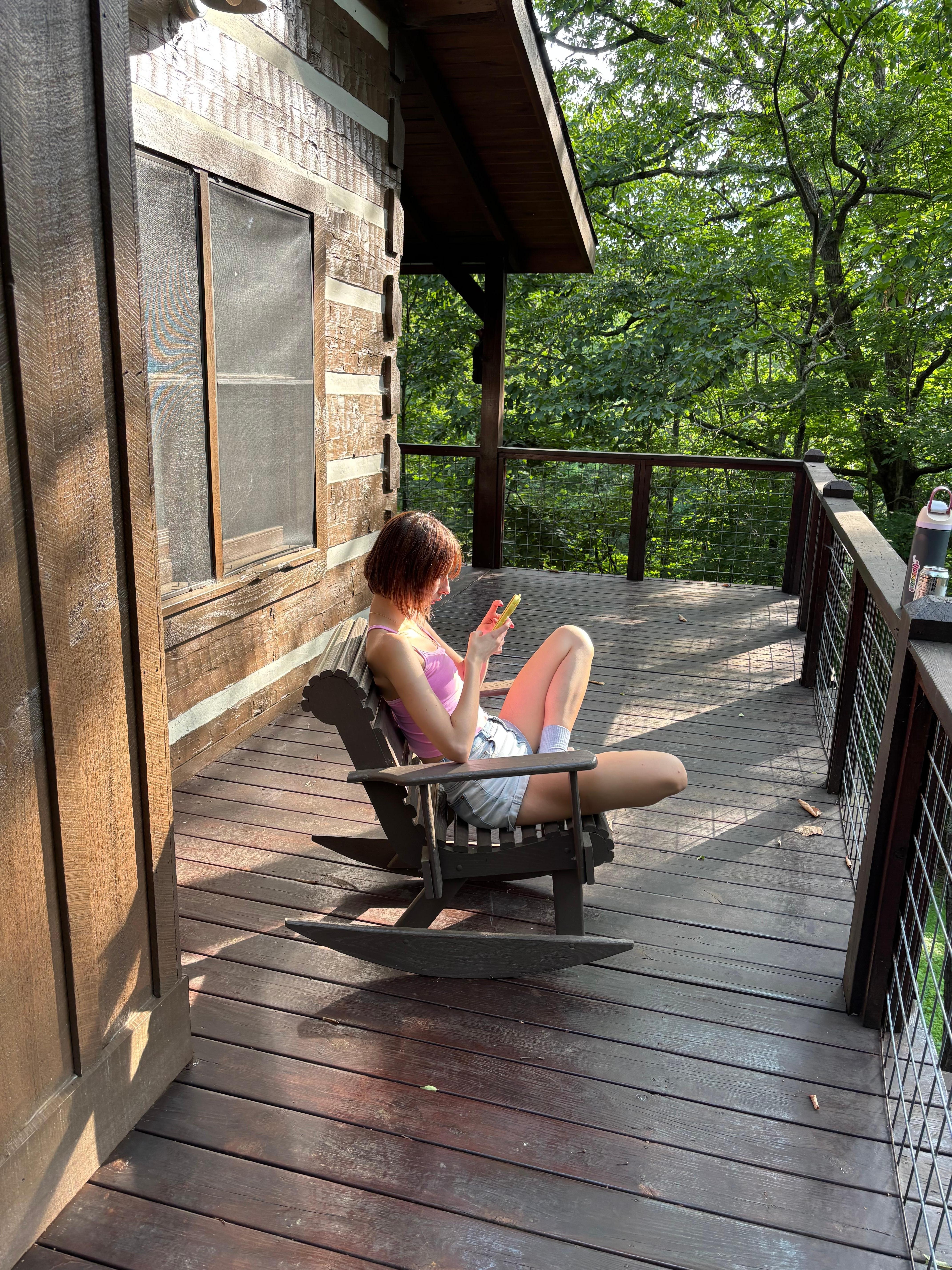 The recent high school grad reading on the deck