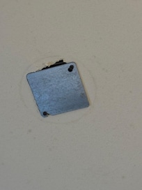 Hole in the ceiling over the bed. They tried to cover with a metal slip??!!