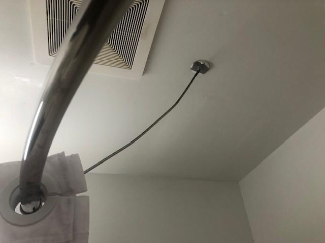 Show rod "anchored" to ceiling.