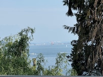 Looking across the water towards Tacoma and watching the sailboats make the most of the gentle breeze while lounging on the deck.